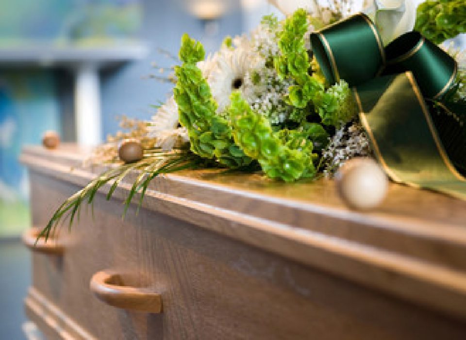 coffin with bouquet of flowers