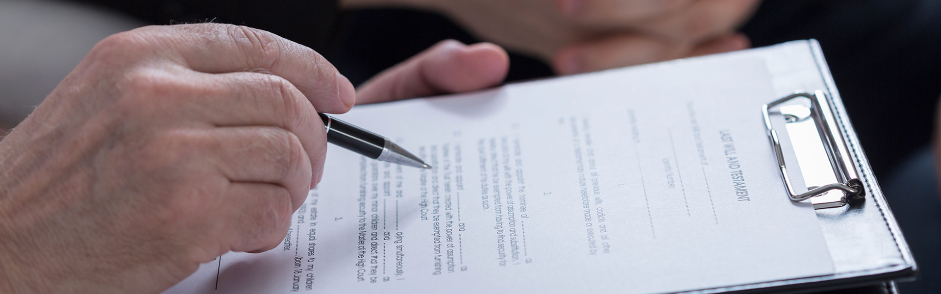 man signing a form