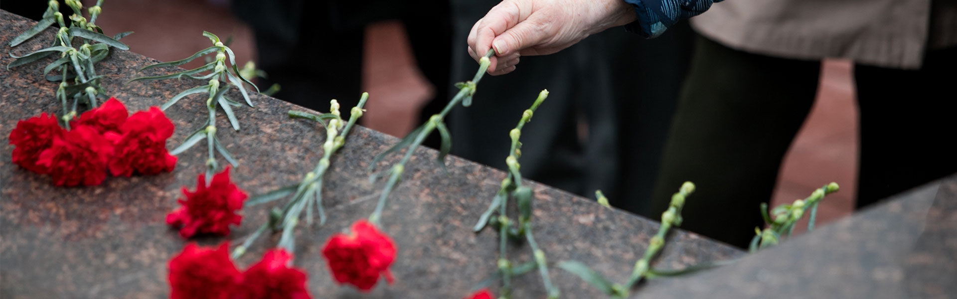 red flowers on top of a coffin