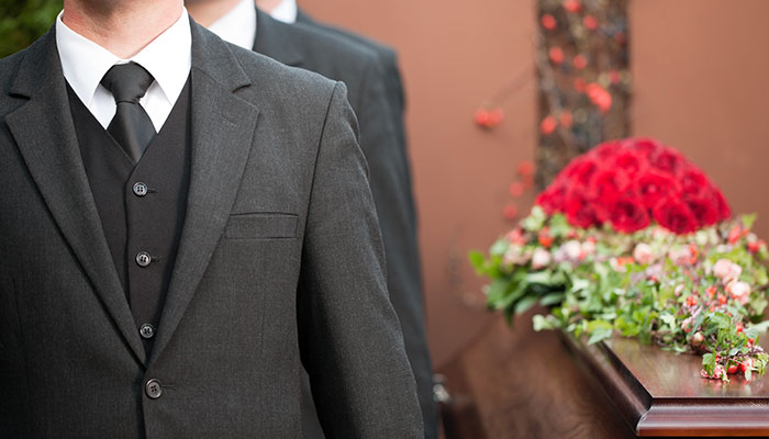 men carrying a coffin